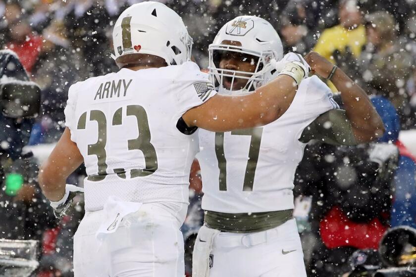 PHILADELPHIA, PA - DECEMBER 09: Darnell Woolfolk #33 of the Army Black Knights celebrates his touchdown with teammate Ahmad Bradshaw #17 in the first half against the Navy Midshipmen on December 9, 2017 at Lincoln Financial Field in Philadelphia, Pennsylvania. (Photo by Elsa/Getty Images) ** OUTS - ELSENT, FPG, CM - OUTS * NM, PH, VA if sourced by CT, LA or MoD **