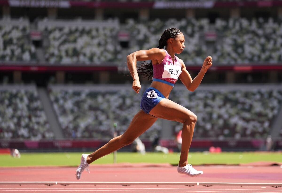 FILE - Allyson Felix, of United States races in a women's 400-meter heat at the 2020 Summer Olympics, Tuesday, Aug. 3, 2021, in Tokyo, Japan. As the most decorated female track athlete in the history of the Olympics, hardly a day goes by when Allyson Felix isn’t reminded of her long list of accomplishments. Introduce her by mentioning that huge haul of 11 Olympic medals and the 18 pieces of gold (mostly), silver and bronze hardware that make her the most decorated competitor -- male or female -- in the history of the athletics world championships, and she’s hardly phased. (AP Photo/Martin Meissner, File)