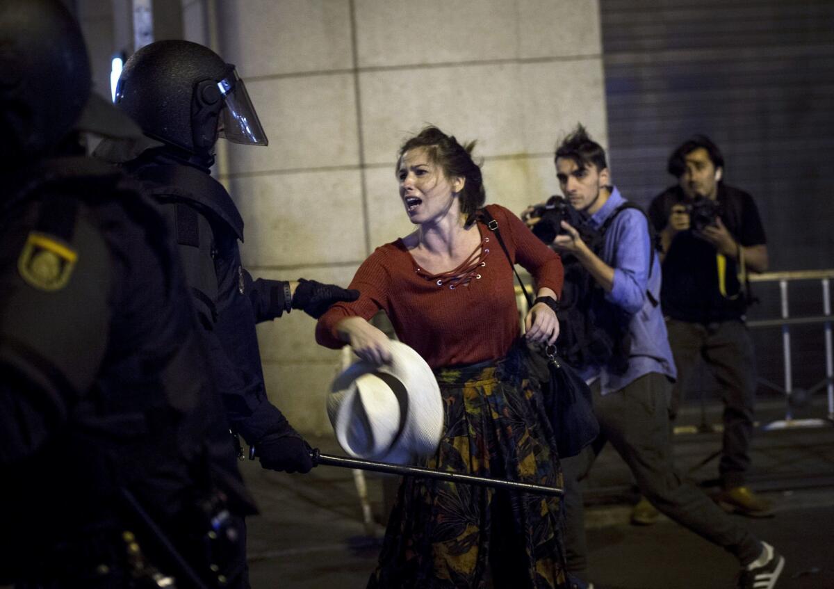 A National Police member struggles with a demonstrator who gathered in favor of the right to decide in Catalonia held at the Puerta Sol in Madrid.