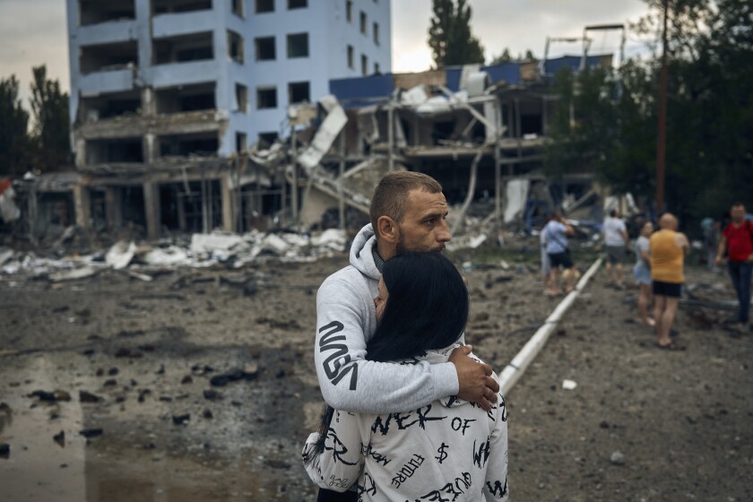 A couple comfort each other after Russian shelling in Mykolaiv, Ukraine, on Wednesday.