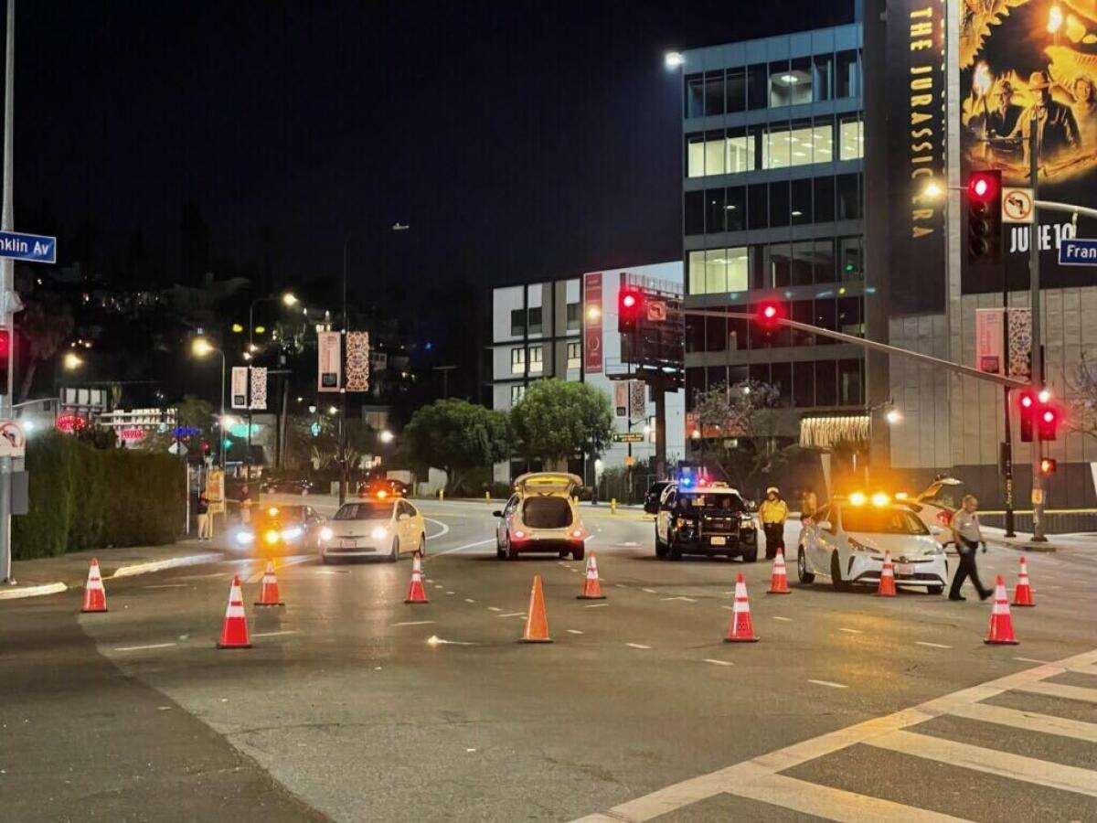 A city street is blocked by cones