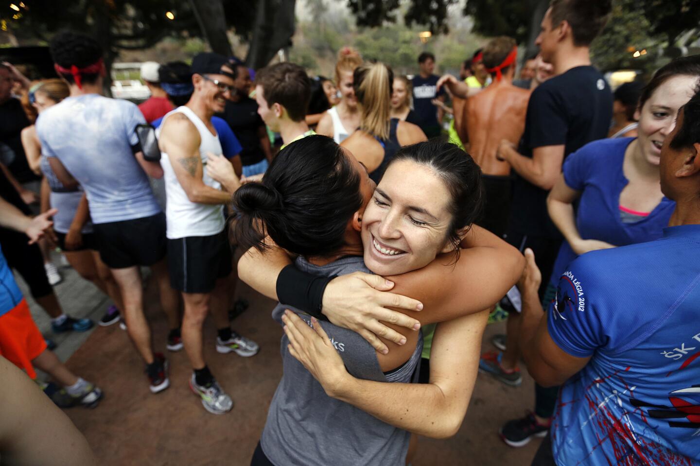 Runners gather at the Hollywood Bowl's box office to start with warm-ups and hugs in a show of camaraderie and encouragement before running the Bowl's steps with November Project L.A., a free fitness group that gathers year-round.
