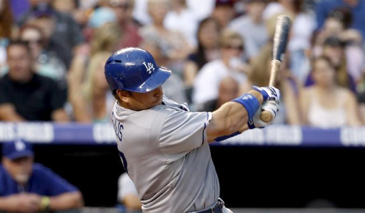 A.J. Ellis drives in Hanley Ramirez with a two-out RBI single in the fourth inning of the Dodgers' win over the Colorado Rockies, 10-8.