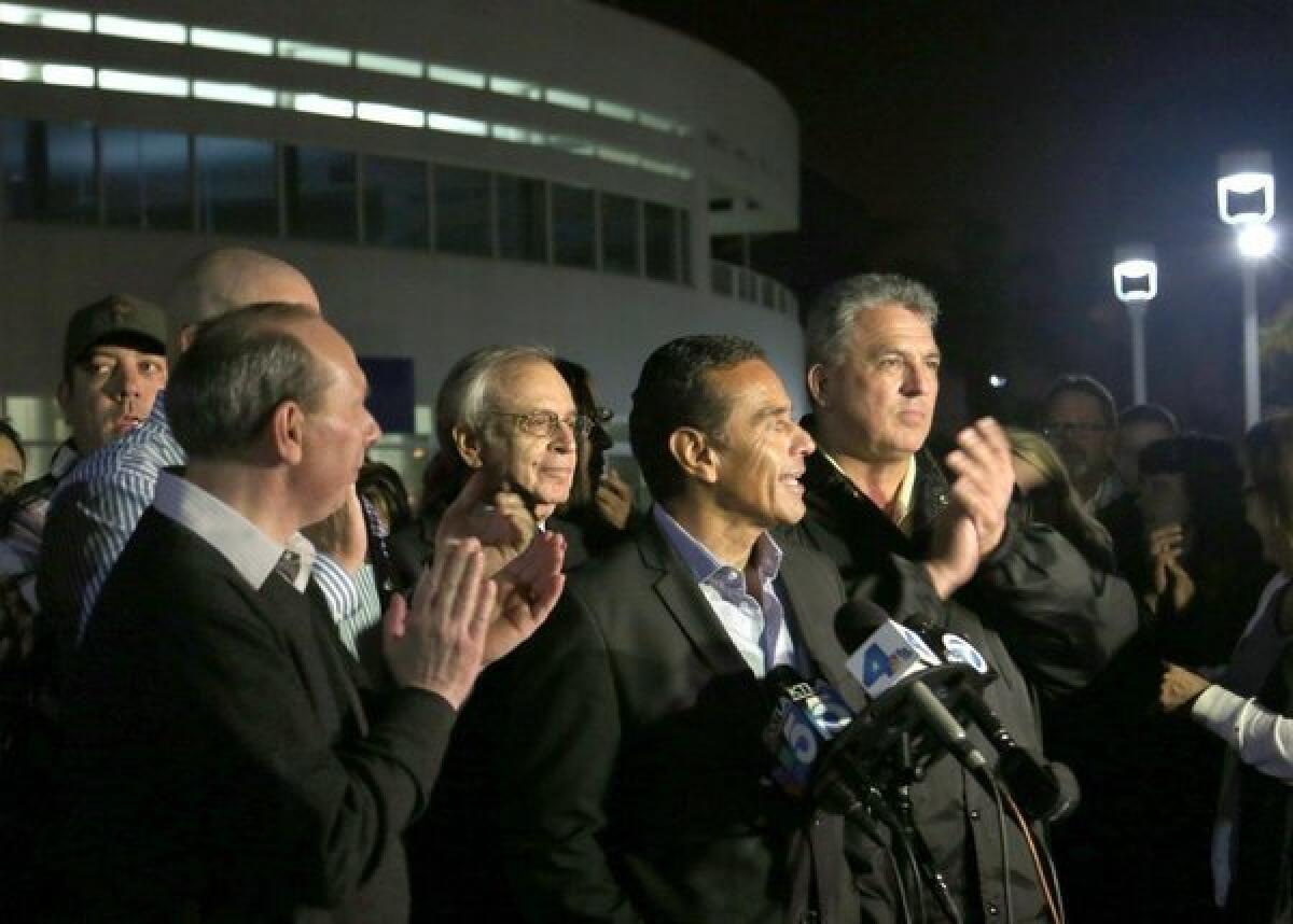 L.A. Mayor Antonio Villaraigosa is joined by union officials and management representatives in announcing the end of a walkout that hobbled the nation's busiest seaport complex for eight days.