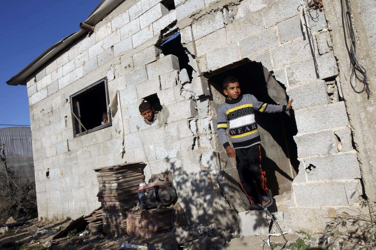 Palestinian children inspect the damage done to a house following an Israeli airstrike that injured two Palestinians in the southern Gaza Strip town of Rafah.