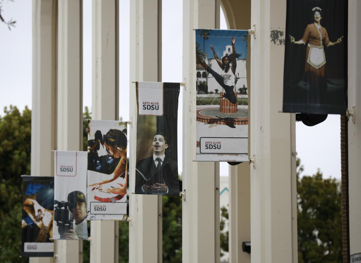 Posters hang from columns outside the Don Powell Theatre at San Diego State