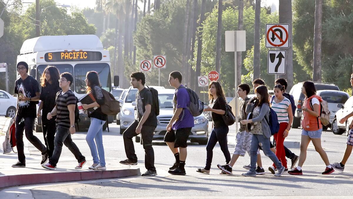 Hoover High School students cross the street on the first day of school.