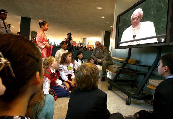 Children from the United Nations International School watch Pope Benedict XVI speak on TV. They performed for him after his address to the U.N. General Assembly.