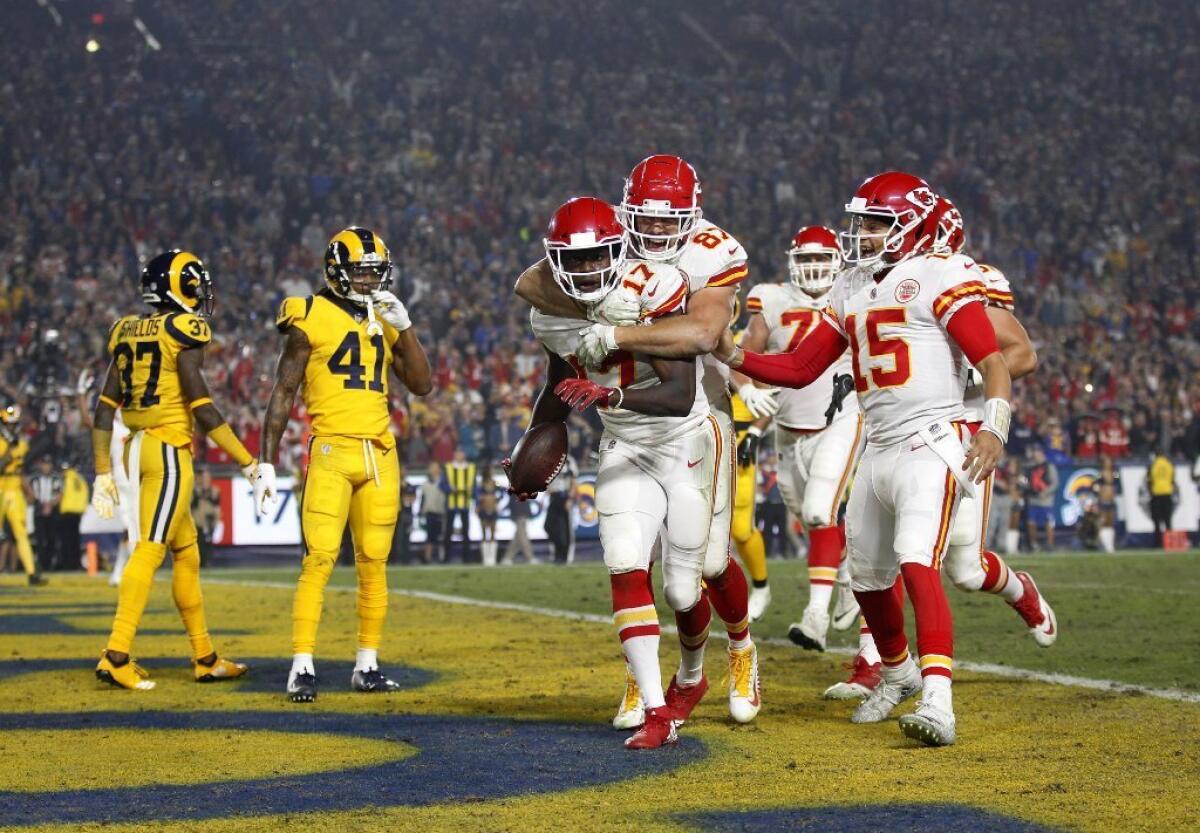 Chiefs' Chris Conley (17) celebrates a touchdown with Travis Kelce (87) and Patrick Mahomes, right.