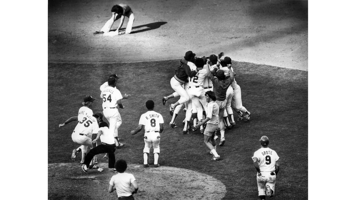 Oct. 7, 1978: As the Los Angeles Dodgers celebrate winning the 1978 National League pennant, Times photographer Larry Sharkey catches a fan stealing second base.