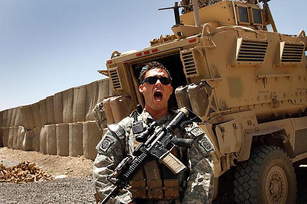 Staff Sgt. Christopher Nealis of the U.S. Army's 82nd Airborne Division, yells for a soldier before heading out on patrol from their combat outpost in Kuhat, in Afghanistan's Kandahar province.