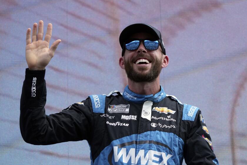 Ross Chastain waves during introductions before a NASCAR Cup Series auto race at Texas Motor Speedway in Fort Worth, Texas, Sunday, Sept. 24, 2023. (AP Photo/LM Otero)