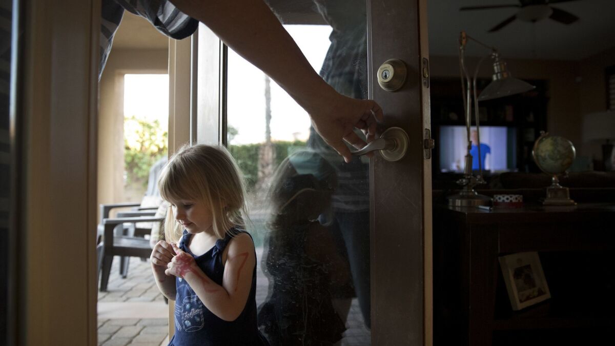 Doug Biggers, whose son, Landon, died of an opioid overdose in La Quinta, Calif., holds a door open for Landon's daughter, Aubrey.