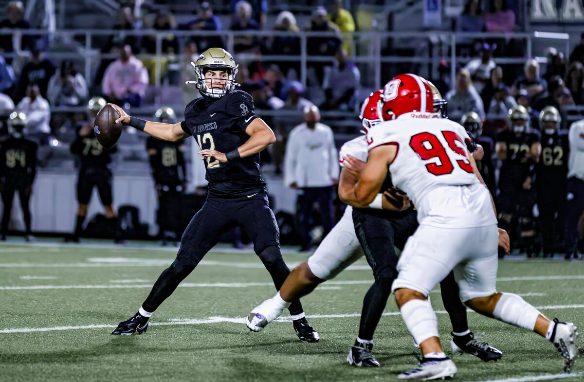 Freshman quarterback Koa Malau'ulu throws from the pocket while under pressure from Orange Lutheran.