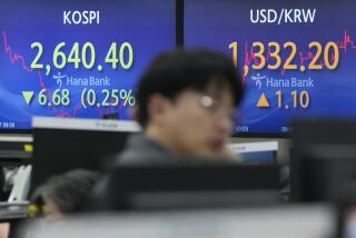 A currency trader watches monitors near the screens showing the Korea Composite Stock Price Index (KOSPI), left, and the foreign exchange rate between U.S. dollar and South Korean won at the foreign exchange dealing room of the KEB Hana Bank headquarters in Seoul, South Korea, Tuesday, Feb. 27, 2024. Asian shares retreated on Tuesday after U.S. stocks edged back from their record heights. (AP Photo/Ahn Young-joon)
