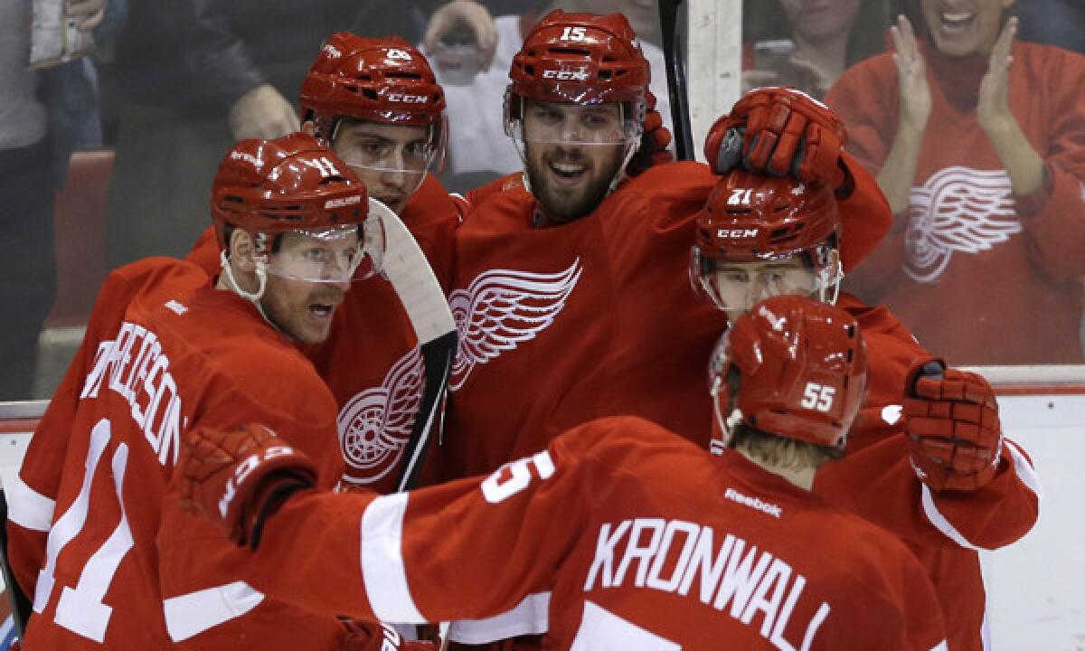 Detroit Red Wings players celebrate a goal by Riley Sheahan during a loss to the Carolina Hurricanes on Friday. The Red Wings' move to the Eastern Conference aided their efforts to maintain their impressive streak of postseason appearances.