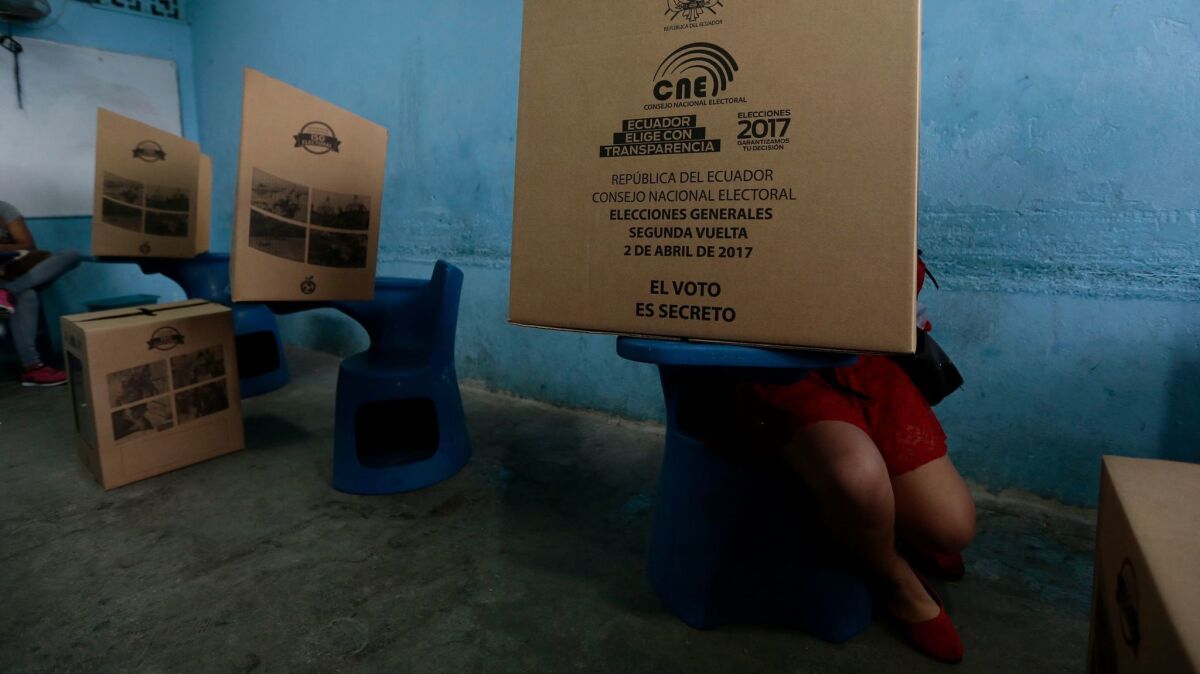 A woman casts her vote during the presidential runoff election in Guayaquil, Ecuador, on April 2, 2017.