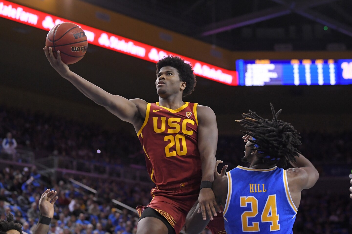 Southern California guard Ethan Anderson, left, shoots as UCLA forward Jalen Hill defends during the first half of an NCAA college basketball game Saturday, Jan. 11, 2020, in Los Angeles. (AP Photo/Mark J. Terrill)