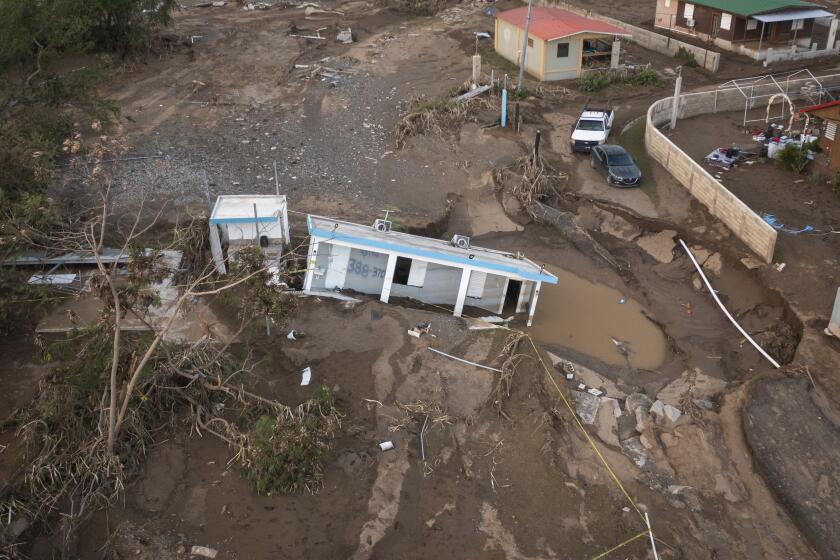 A house lays in the mud after it was washed away by Hurricane Fiona at Villa Esperanza in Salinas, Puerto Rico, Wednesday, Sept. 21, 2022. Fiona left hundreds of people stranded across the island after smashing roads and bridges, with authorities still struggling to reach them four days after the storm smacked the U.S. territory, causing historic flooding. (AP Photo/Alejandro Granadillo)