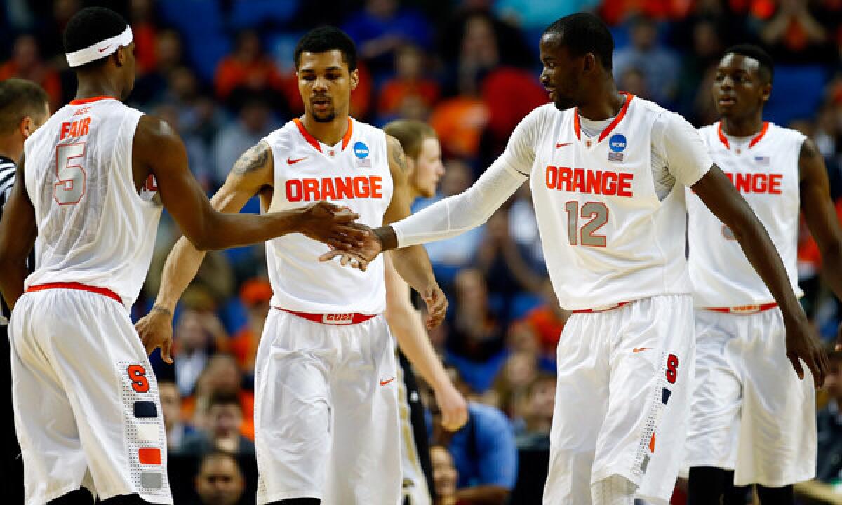 Syracuse's C.J. Fair, left, celebrates with teammates Michael Gbinije, center, and Baye-Moussa Keita during the team's second-round win over Western Michigan in the NCAA tournament on Thursday.