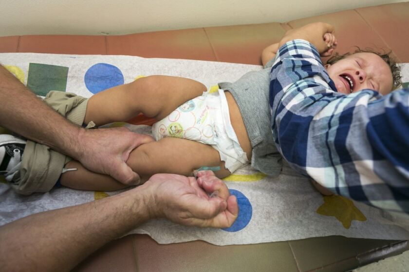 Cameron Fierro, age 1, receives his measles-mumps-rubella vaccine at his pediatrician's office in Northridge.
