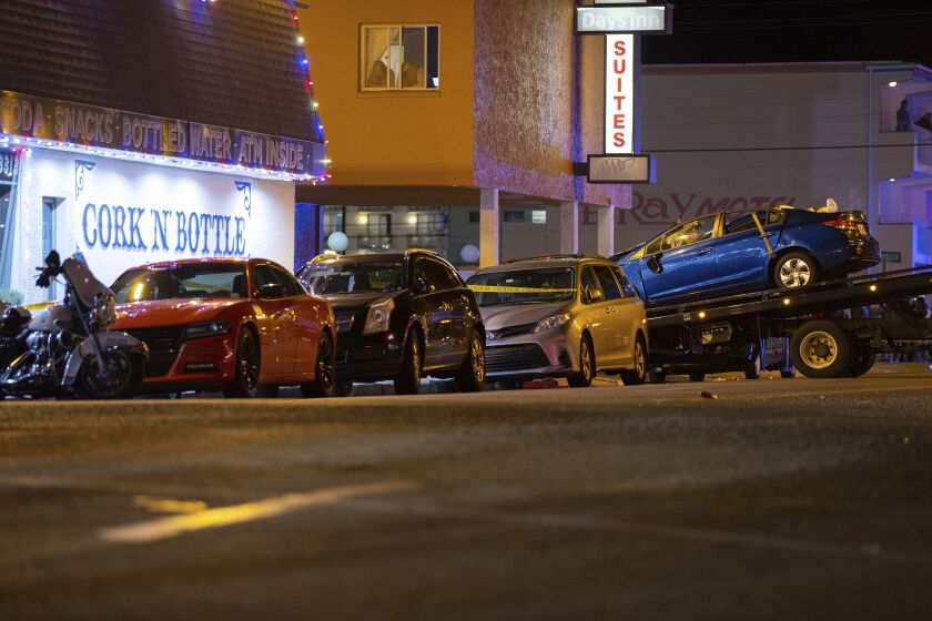 A blue Honda is loaded onto a flatbed tow truck in Wildwood, N.J., late Saturday, Sept. 24, 2022. Authorities say at least two people were killed amid multiple crashes at a pop-up car rally. (Dave Hernandez/NJ Advance Media via AP)