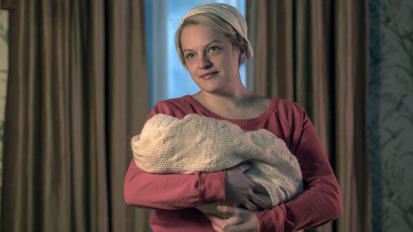 This image released by Hulu shows Elisabeth Moss in a scene from "The Handmaid's Tale." Moss was nominated Thursday for an Emmy for outstanding lead actress in a drama series. The 70th Emmy Awards will be held on Monday, Sept. 17.