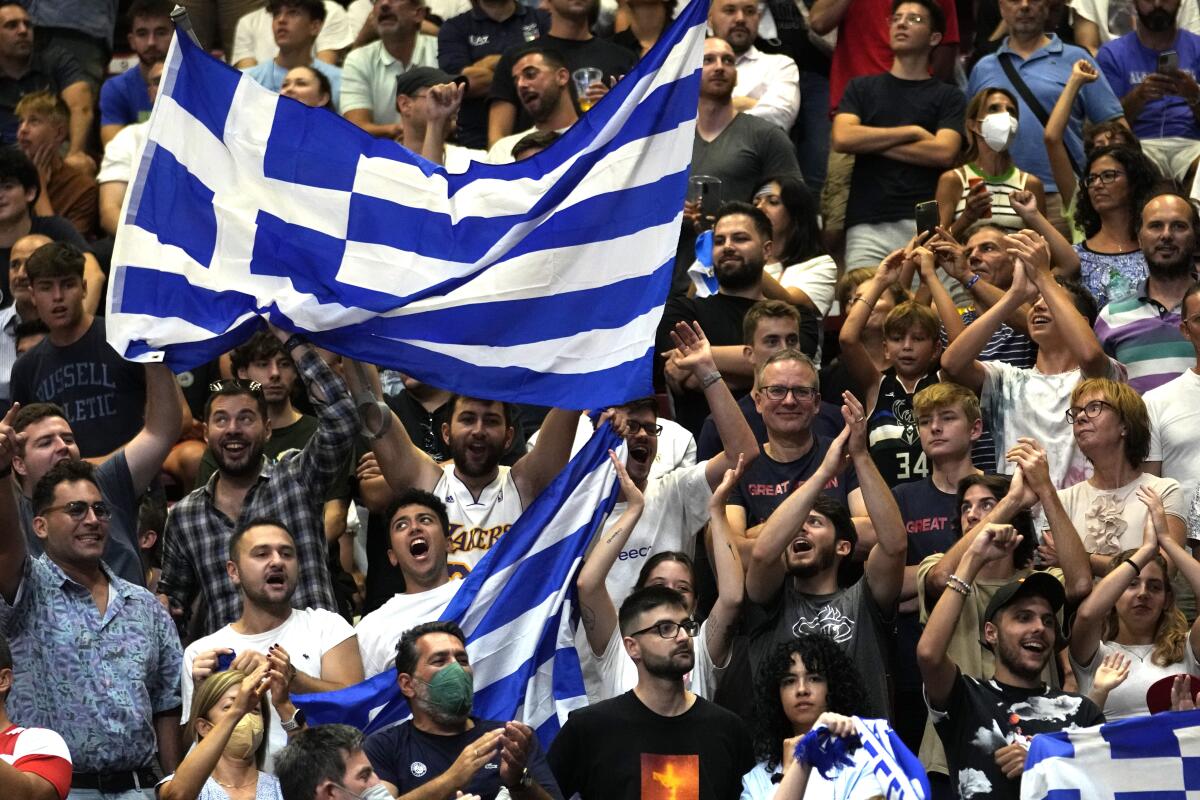 Greece's fans celebrate at the end of the Eurobasket group C basketball match between Croatia and Greece at the Assago Forum, near Milan, Italy, Friday Sept. 2, 2022. Greece beat Croatia 89-85. (AP Photo/Luca Bruno)
