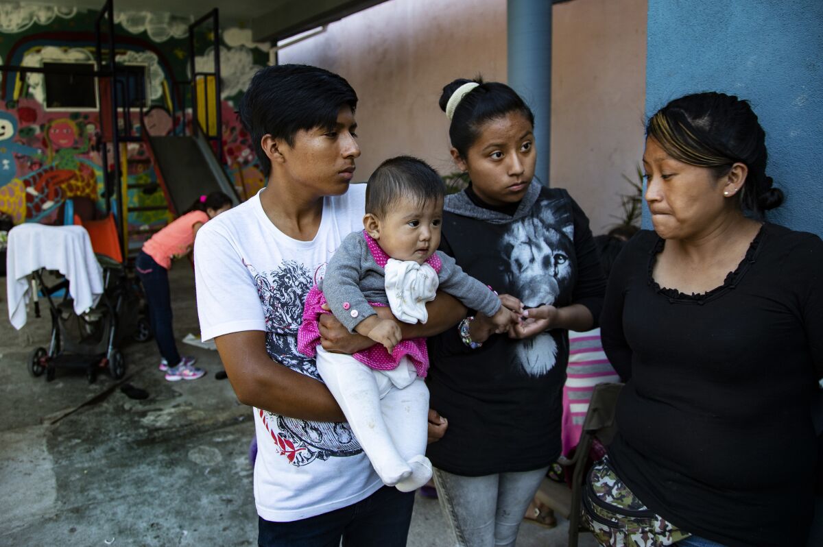 Dalila Pojoy, 33, of Guatemala, right, and her children Davis, 15, Diana, 14, and Bernardethe, 6 months, have been staying in a border shelter in Tijuana, Mexico, for three weeks while waiting to seek asylum in the United States.