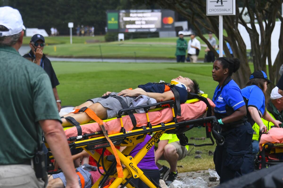A spectator is moved to an ambulance after a lightning strike.