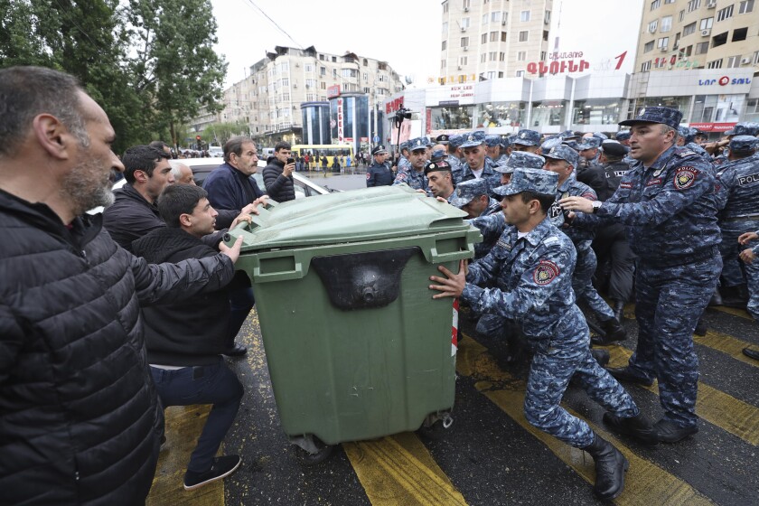 Police clash with demonstrators during a protest rally, in Yerevan, Armenia, Monday, May 2, 2022. Police in Armenia's capital on Monday detained 125 anti-government demonstrators that were blocking streets to protest against Prime Minister Nikol Pashinyan. (Vahram Baghdasaryan/Photolure via AP)