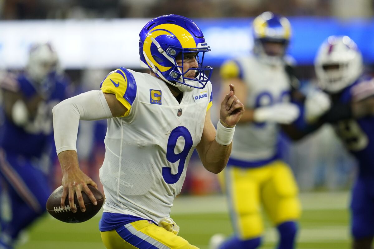 Rams quarterback Matthew Stafford (9) heads the ball.