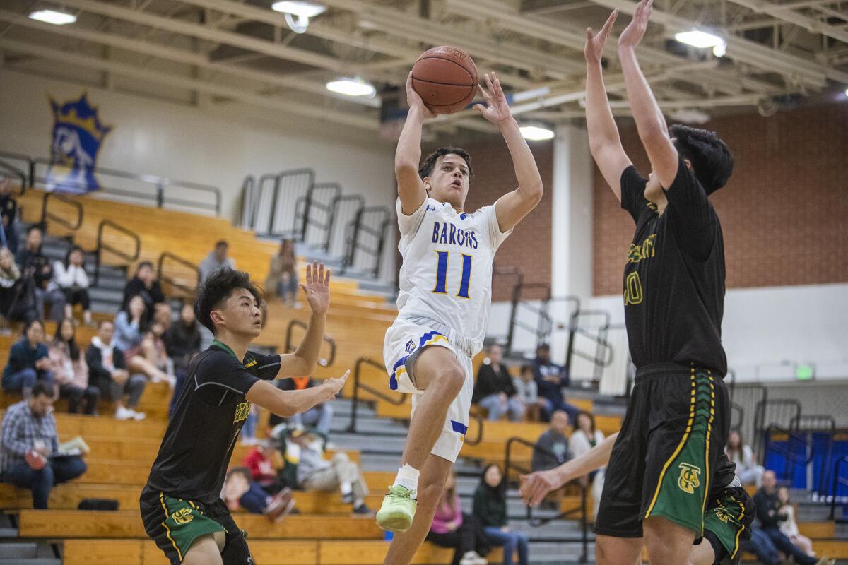 Fountain Valley's Macarhy Morris shoots between Temple City's Eric Khaw, left, and Elton Lo in the second round of the CIF Southern Section Division 3A playoffs on Friday.