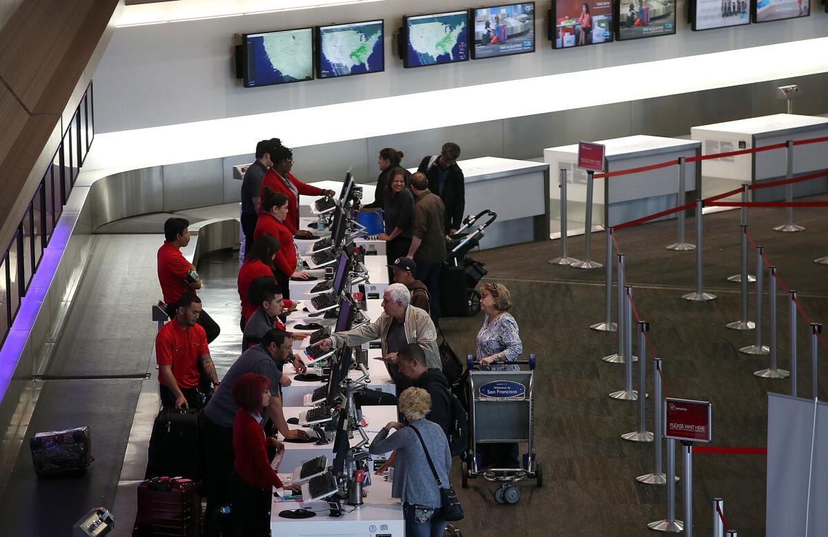 Passengers check in for Virgin America flights at San Francisco International Airport.