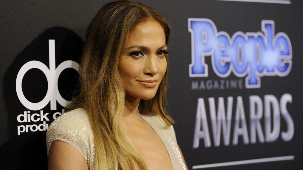 Jennifer Lopez, shown Dec. 18 at the People Magazine Awards, was driving her Rolls-Royce when she was hit by a drunk driver, police say.