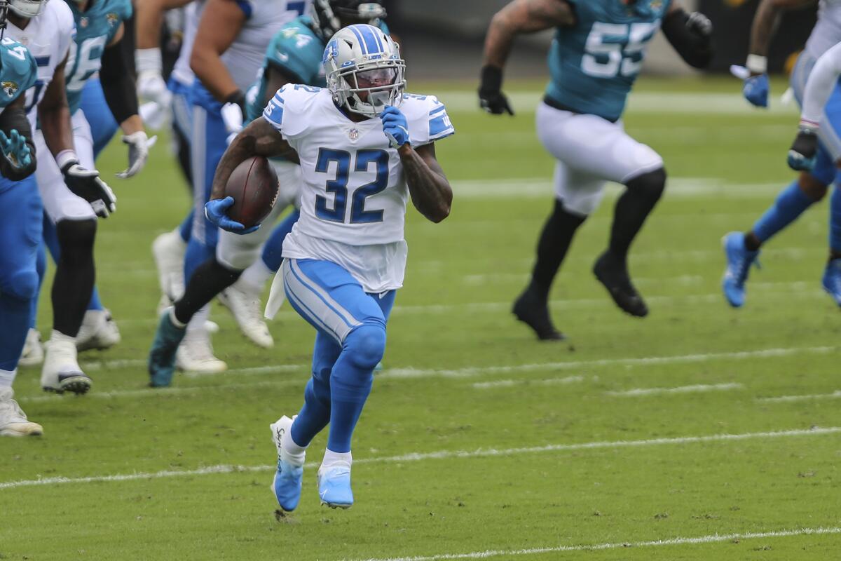 Detroit Lions running back D'Andre Swift finds open running room in Sunday's win.