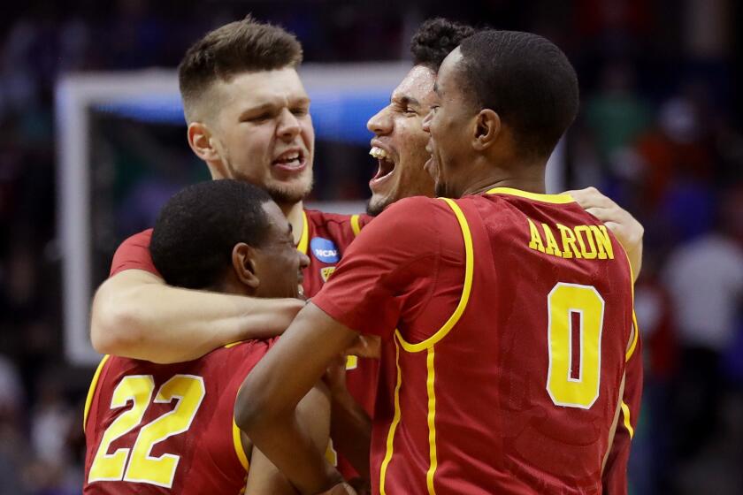USC players (from left) De'Anthony Melton (22), Nick Rakocevic, Bennie Boatwright and Shaqquan Aaron (0) celebrate after defeating Southern Methodist, 66-65, to advance to the second round of the NCAA tournament.