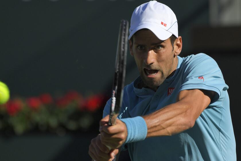 Novak Djokovic returns a shot to Nick Kyrgios during their match Wednesday in the BNP Paribas Open.