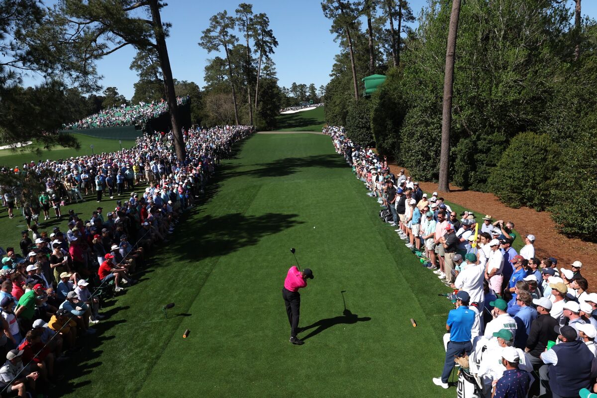 Tiger Woods tees off at the 18th hole.