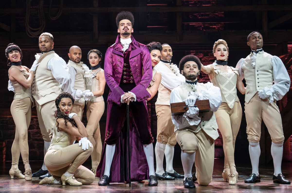 Suni Reid stands on stage with other "Hamilton" cast members 
