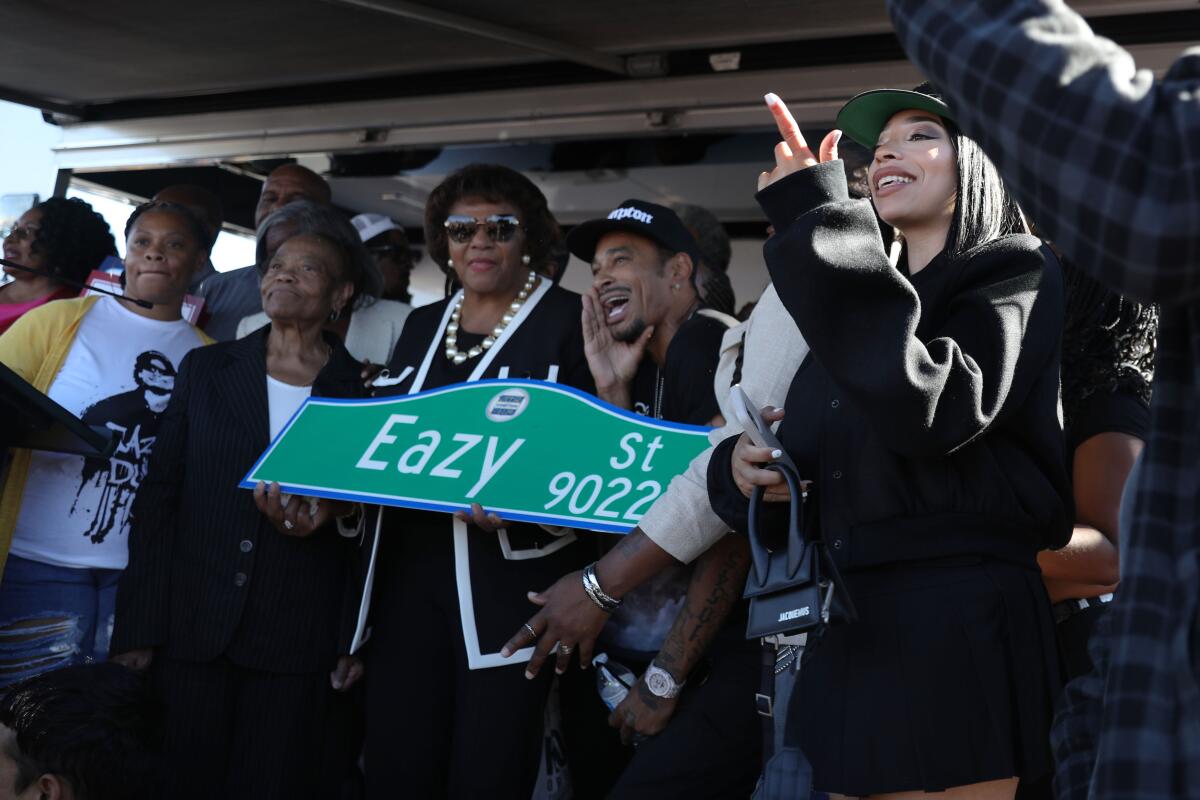  Family, friends, and politicians hold the new Eazy St. sign while some sing along to the song Boyz N The Hood.