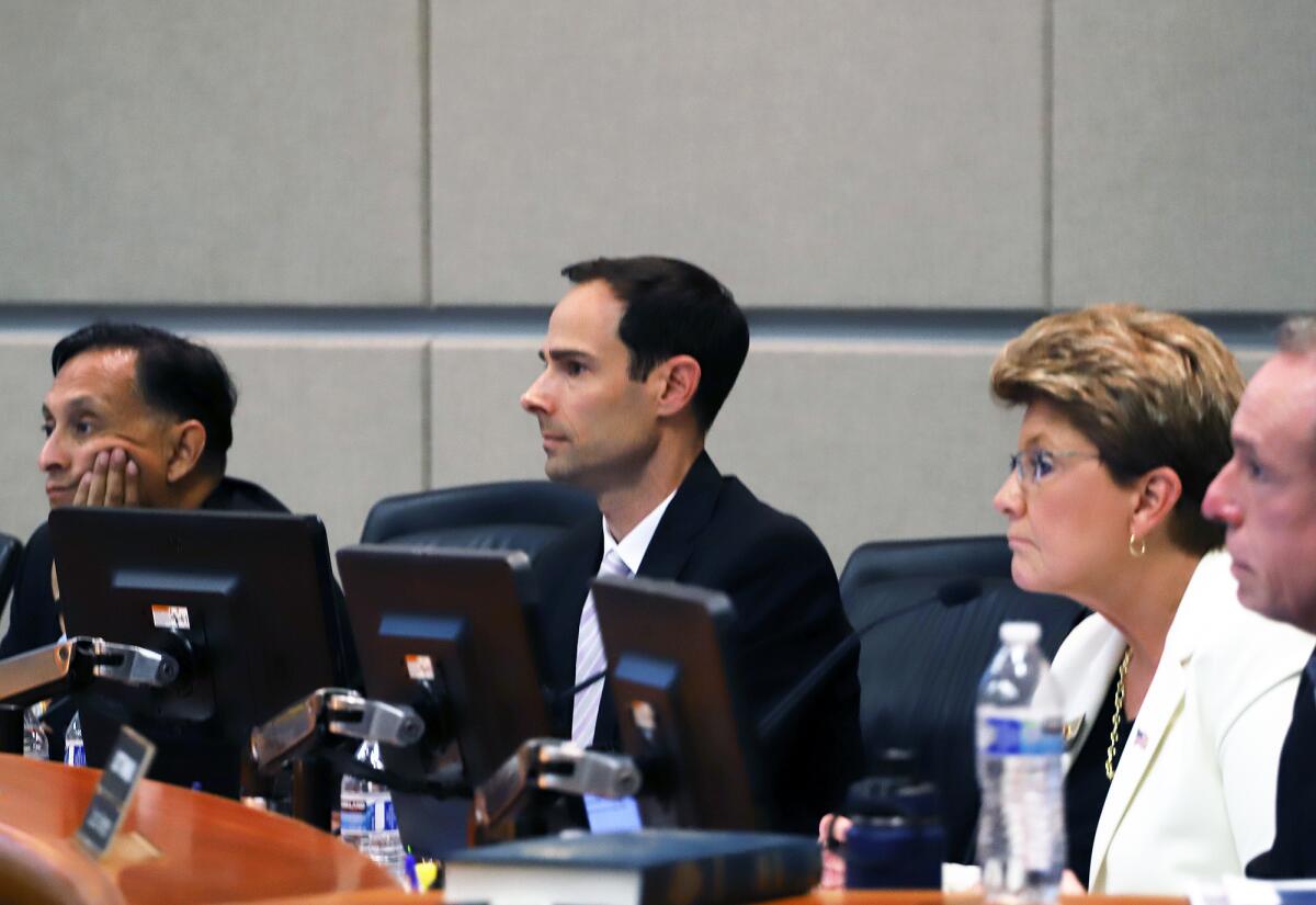 Cypress Mayor David Burke, center, listened to public comments during a council meeting in April.