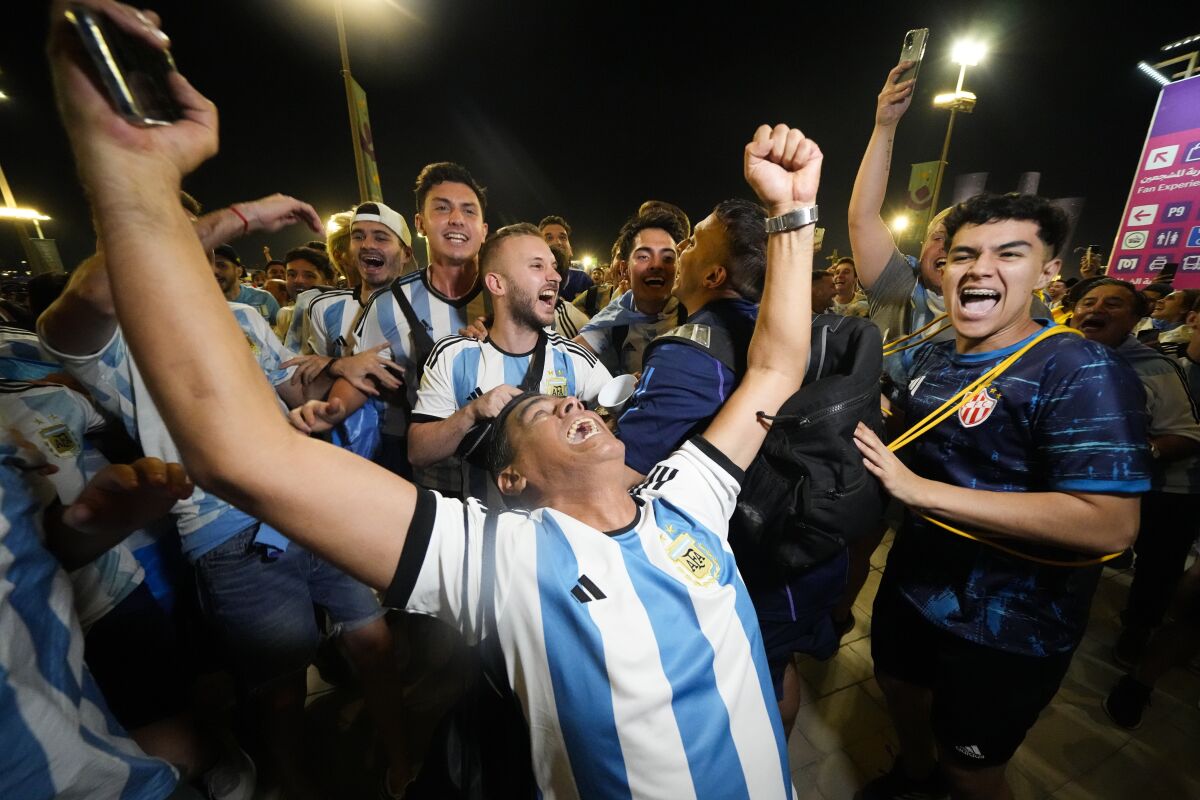 Supporters from Argentina celebrate outside Lusail Stadium following their team's 2-0 victory over Mexico in a World Cup group C soccer match in Lusail, Qatar, Saturday, Nov. 26, 2022. (AP Photo/Julio Cortez)