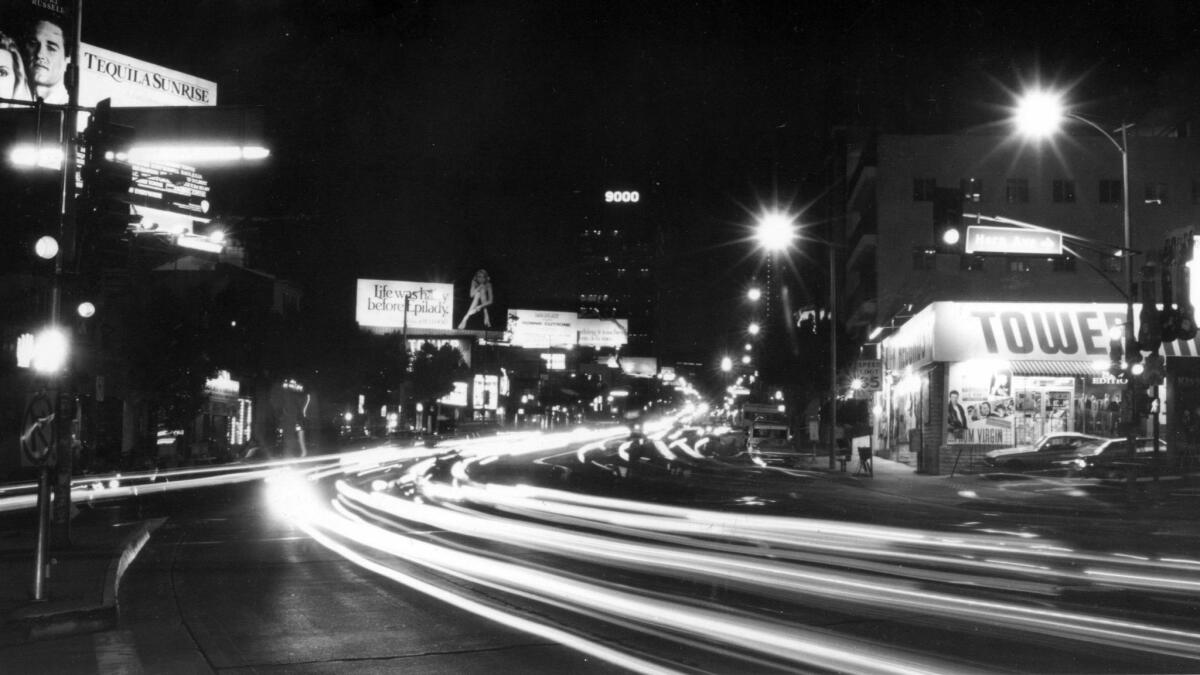 The bright lights beckon night visitors to the famous Sunset Strip in the Horn Avenue area on Dec. 13, 1988 .