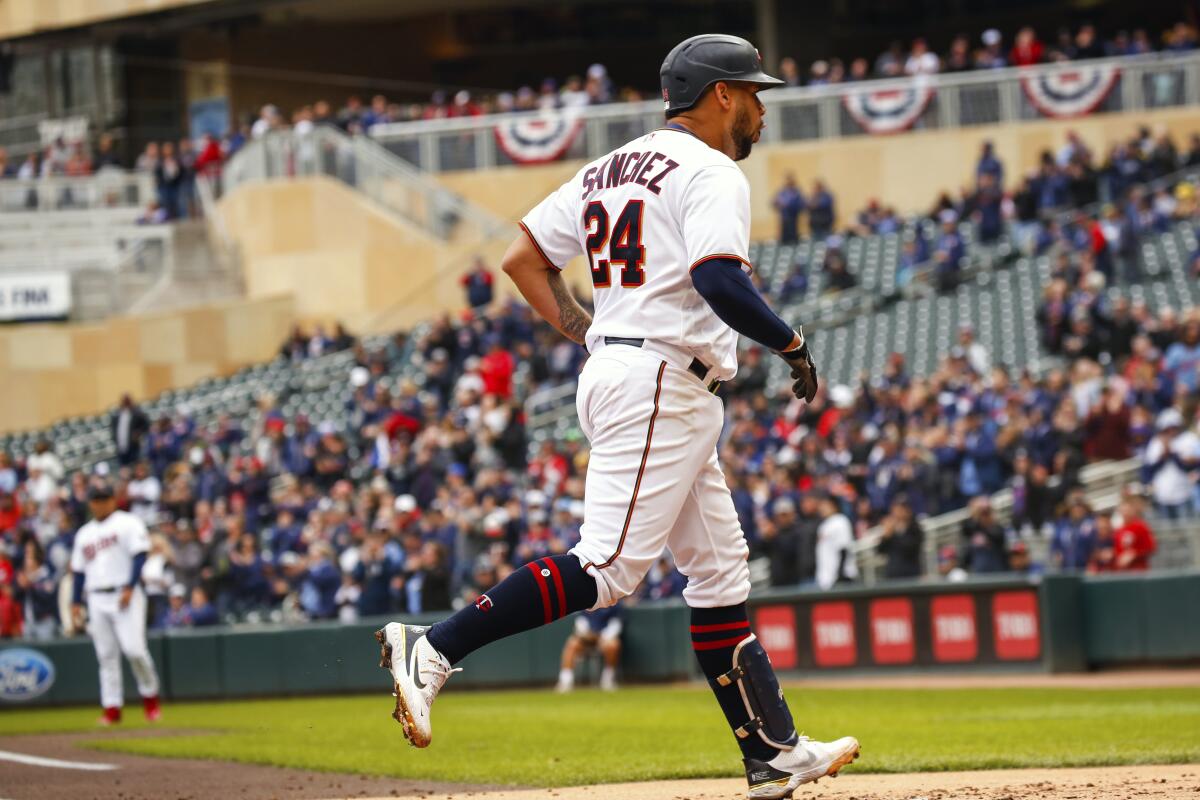 Minnesota Twins' Gary Sanchez (24) rounds to home base after hitting a grand slam against the Seattle Mariners during the first inning of a baseball game, Sunday, April 10, 2022, in Minneapolis. (AP Photo/Nicole Neri)