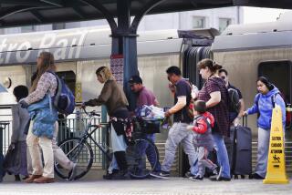 Commuters disembark from a Metro Rail train at Union Station in Downtown Los Angeles on Monday, Nov. 13, 2023. Los Angeles drivers are being tested in their first commute since a weekend fire that closed a major elevated interstate near downtown. Commuters were urged to work from home or take public transportation into downtown Los Angeles. (AP Photo/Richard Vogel)