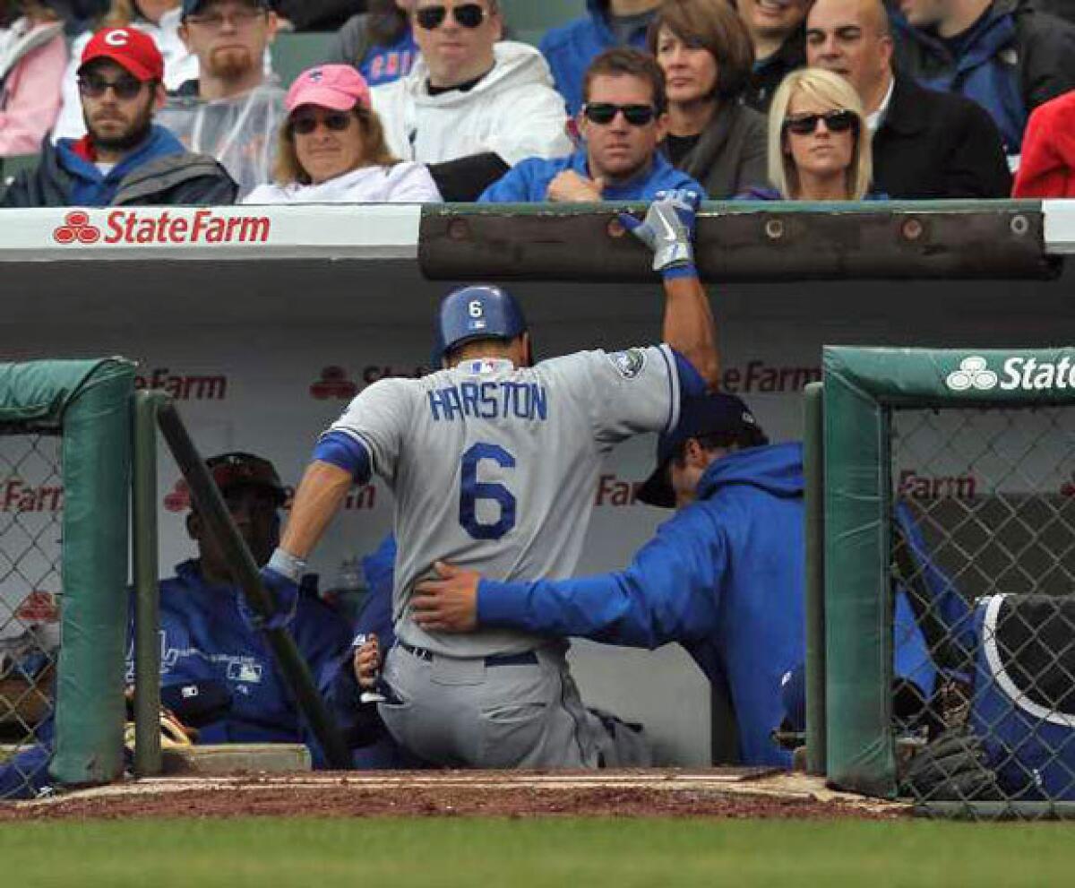 Jerry Hairston is helped down the steps of the dugout after injuring his leg against the Chicago Cubs at Wrigley Field.
