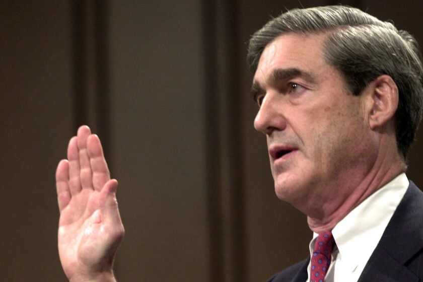 FILE - In this July 30, 2001, file photo, Robert Mueller is sworn in at the start of his testimony during his confirmation hearing before the Senate Judiciary Committee on Capitol Hill in Washington, to be the FBI director. Mueller took office as FBI director in 2001 expecting to dig into drug cases, white-collar misdeeds and violent crime. A week later was Sept. 11. Overnight, his mission changed and Mueller spent the next 12 years wrestling the agency into a battle-hardened terrorism-fighting force. (AP Photo/Dennis Cook, File)