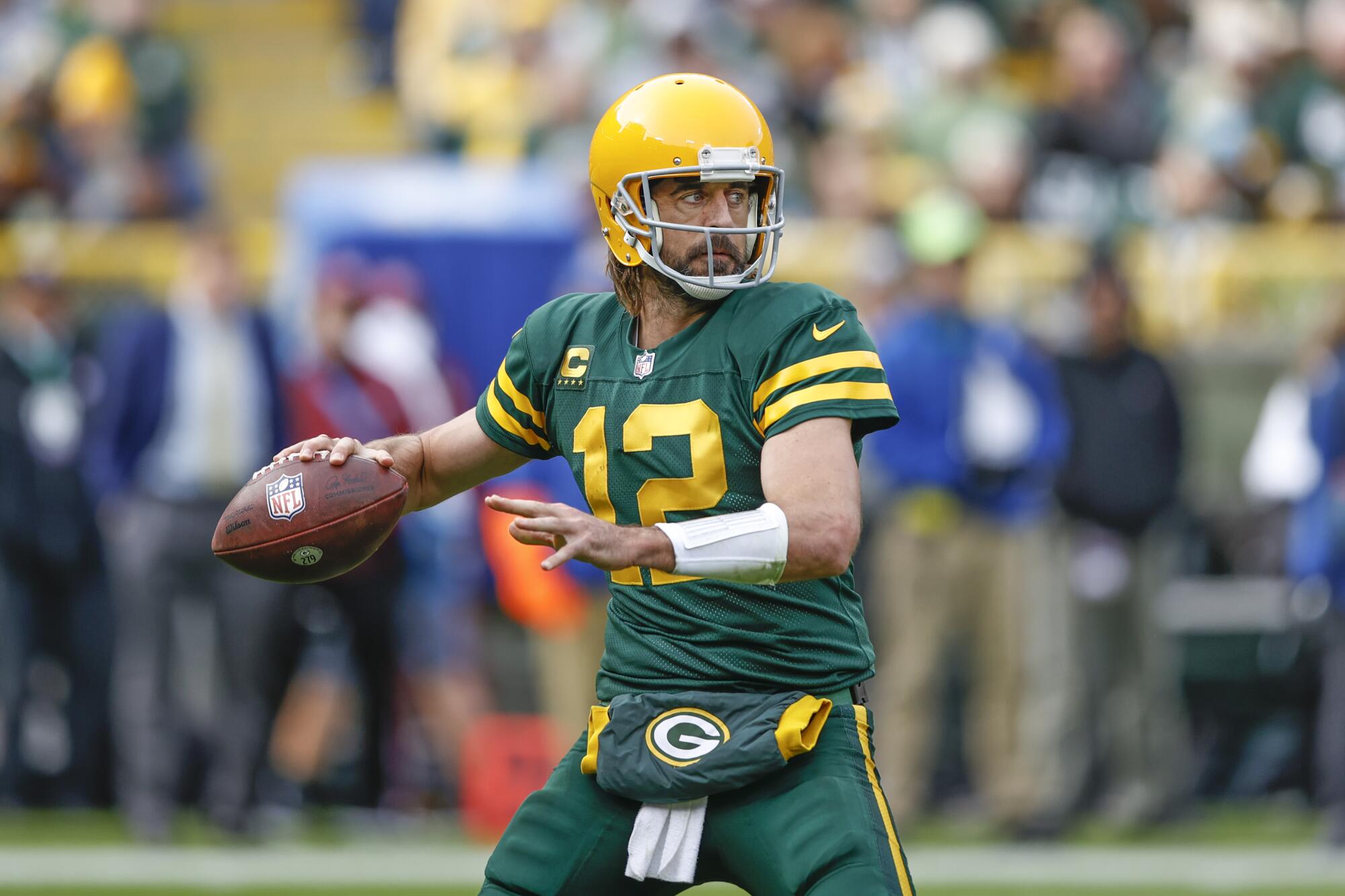 Green Bay Packers quarterback Aaron Rodgers looks to pass the ball.