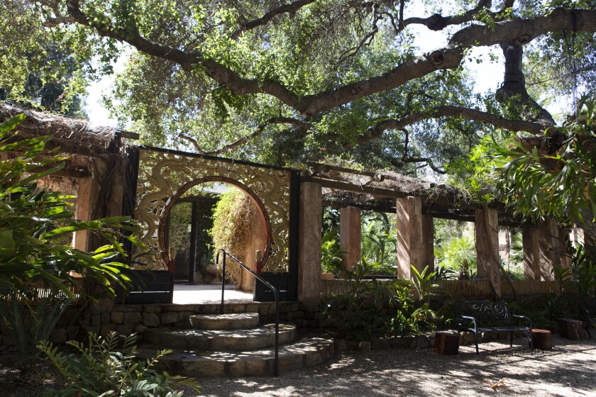 Tall mature oaks sprawl over the shady tranquil entrance to the Taft Gardens' amphitheater.